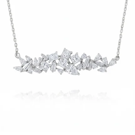 Diamond necklace with clusters of square, marquise, and baguette-cut stones set in white metal chain, centered sparkle against white background.