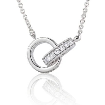 Silver pendant necklace with a hollow circular ring and a diamond-studded bar passing through it on a matching chain.