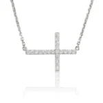 Silver necklace with a diamond-studded cross pendant hanging from a chain.
