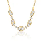Gold-tone necklace with diamond-studded links forming a curved strand on a white background.