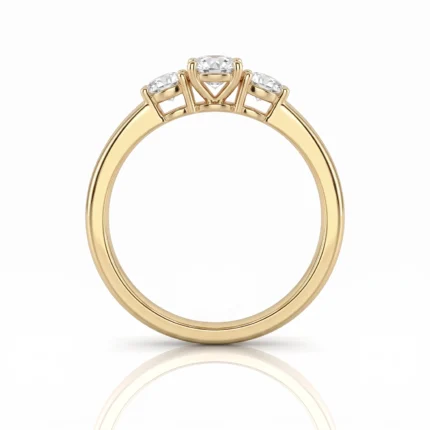 Yellow gold engagement ring with a triple-diamond setting and raised prongs viewed from the side