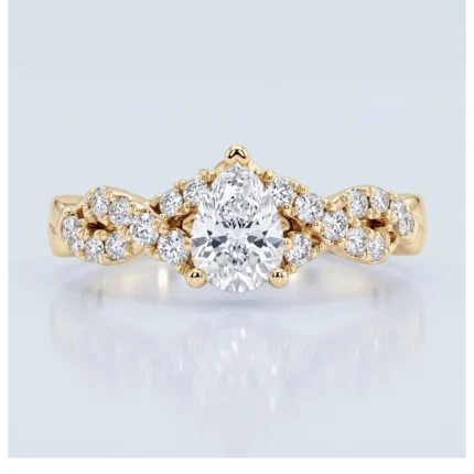 Yellow gold ring featuring a large round brilliant center diamond with a row of smaller diamonds along a twisted band on both sides, creating a pavé design.