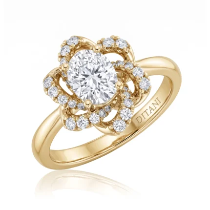 Yellow gold ring with a large round center diamond surrounded by two concentric halos of smaller diamonds in a floral design.