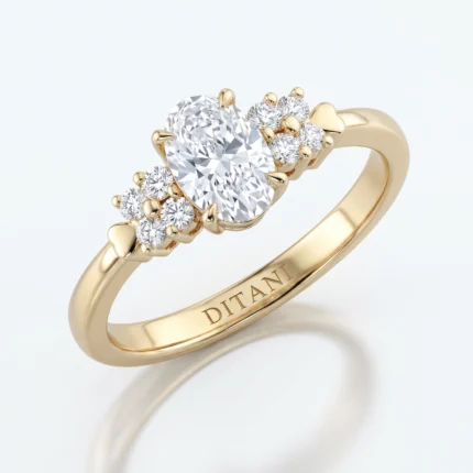 Gold ring with a large oval center diamond, surrounded by small diamonds and tiny heart shapes along the band; 'DITANI' engraved on the inside of the band.