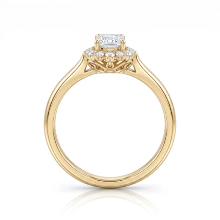 Gold engagement ring with a rectangular center diamond and a halo of smaller diamonds, shown from the side/high relief.