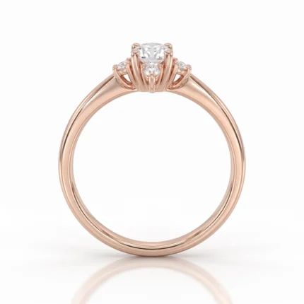 Rose gold engagement ring with a central round diamond and small diamonds on the prong setting.