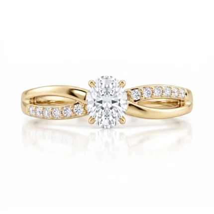 Gold ring with a large central diamond and pavé-set diamonds along the band, oval-cut center stone, in a bright studio shot.