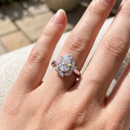 Engagement ring on a rose-gold band with a large central round diamond surrounded by a floral cluster of smaller stones.