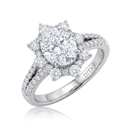 Engagement ring with an oval center diamond surrounded by a halo of smaller diamonds and a pavé-diamond band on white metal band (DITANI engraved).
