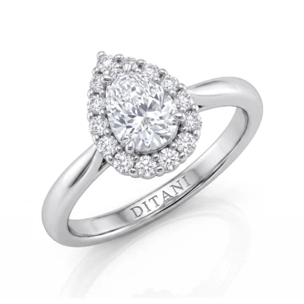 Engagement ring with an oval center diamond surrounded by a halo of smaller diamonds in white metal. Engraving 'DITANI' on the band is visible.