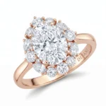 Rose gold engagement ring with a large central diamond surrounded by a halo of smaller diamonds.