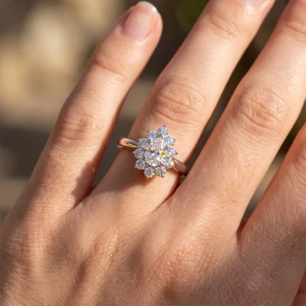 Rose-gold ring with a floral cluster of diamonds on the left-hand ring finger, photographed in soft outdoor light.