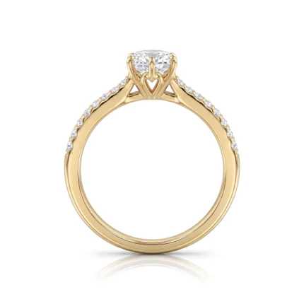 Gold engagement ring with a large center diamond and pavé diamonds along the band, featuring a heart detail beneath the setting.