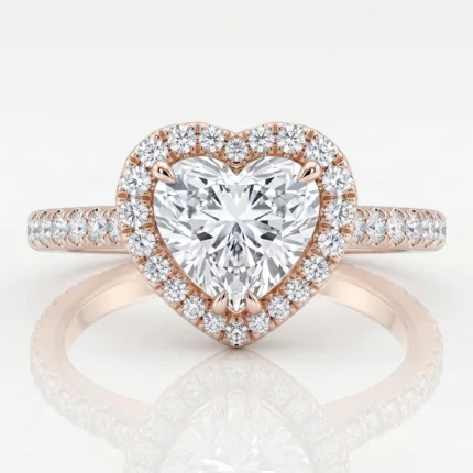Rose gold heart-shaped diamond ring with a halo of smaller diamonds and a pavé band on each side.