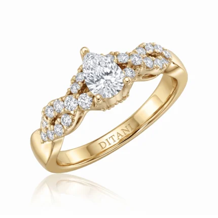 Gold ring with a pear-cut center diamond surrounded by pavé diamonds and 'DITANI' engraved on the inside