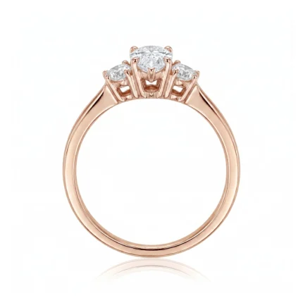 Rose gold ring with a central diamond flanked by two smaller diamonds, full circle band visible.