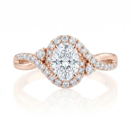 Rose gold engagement ring featuring a large oval center diamond with a surrounding diamond halo and pavé-diamond shoulders.