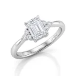 Emerald-cut diamond engagement ring with pave diamonds on the sides in white gold or platinum finish.