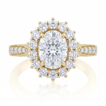 Gold halo engagement ring with a large central diamond surrounded by a ring of smaller diamonds; pavé-set diamonds along the gold band on each side.