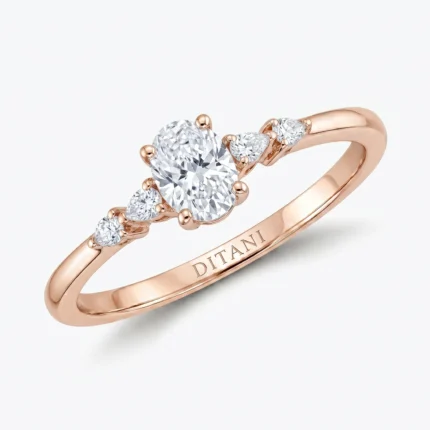 Rose gold ring with a large central diamond and two smaller side diamonds, band engraved with DITANI on the inner side.