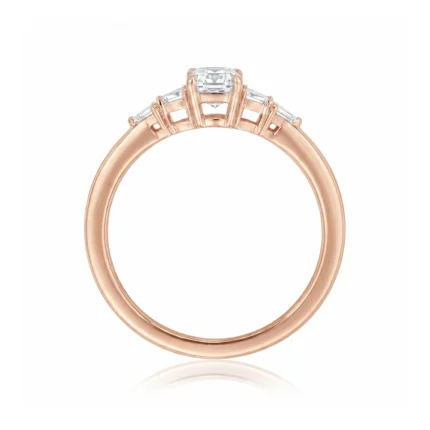 Rose gold ring with a central rectangular diamond and baguette-cut side stones, set in a three-stone design against a white background (product photo).