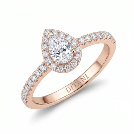 Rose gold engagement ring with a pear-cut center diamond surrounded by a diamond halo and pavé-set band.