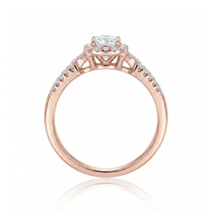 Rose gold engagement ring with a central diamond surrounded by a diamond halo and small diamonds along the band