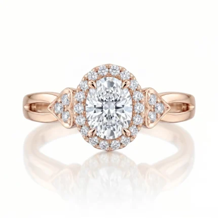Rose gold engagement ring with an oval center diamond and a diamond halo nearby the band edges