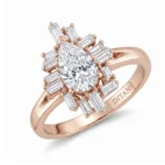 Rose gold engagement ring with a pear-cut center diamond surrounded by a halo of baguette diamonds on a thick band