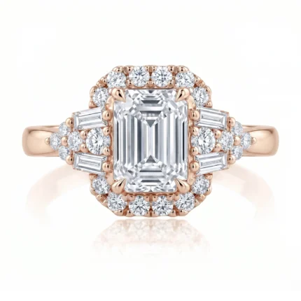 Rose gold ring with a large emerald-cut center diamond, surrounded by a halo of round diamonds and side baguette stones on a polished band.