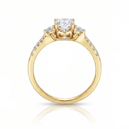 Yellow gold ring with a prominent round center diamond and small diamonds along the band, in an ornate setting