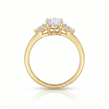 Gold ring in yellow gold with a central large diamond and two side stones in a prong setting.