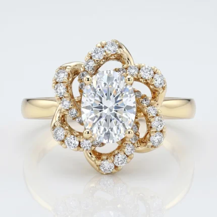 Gold ring with a large central diamond and a halo of smaller diamonds set in intricate gold swirls.