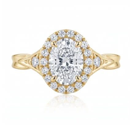 Gold ring with an oval center diamond surrounded by a halo of small diamonds, in a split shank design.