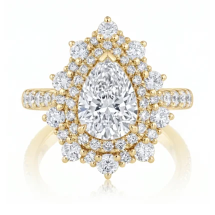 Gold ring with a large pear-shaped diamond at center, surrounded by a halo of smaller diamonds on a pavé band.