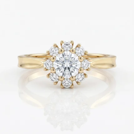 Gold halo engagement ring with a large central diamond surrounded by smaller diamonds, on a reflective white surface.