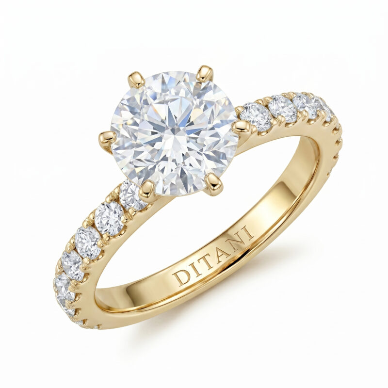 Gold ring with a large round-cut diamond and smaller diamonds along the band, set in a polished gold setting against a white background.